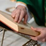 Dłonie księdza na biblii sprawującego Msze Święte