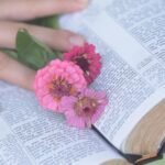 Biblia i leżące na niej kwiaty